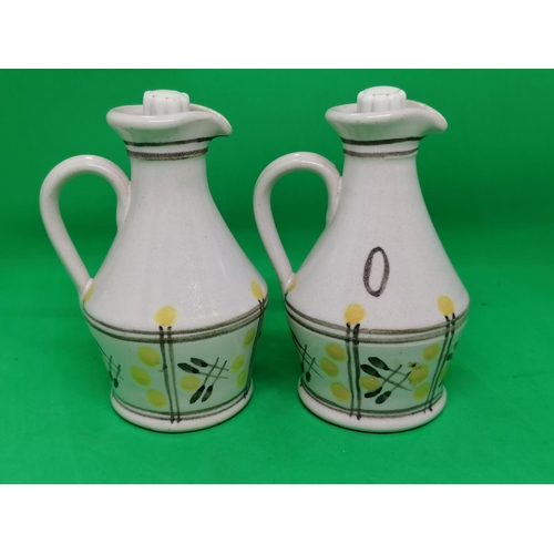 282 - A pair of Buchan pottery oil and vinegar bottles and stoppers, loosely decorated with flowers, 9 cm ... 
