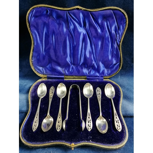262 - A boxed set of 6 silver teaspoons and matching tongs each attractively pierced with bell flowers, 19... 