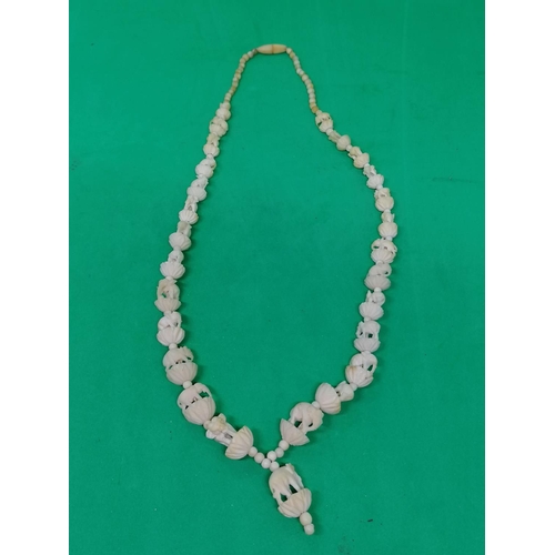 270 - A vintage Indian bone necklace carved with elephants, with a drop, 52cm long