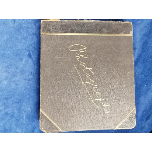 275 - Another photograph album from early 20C, leather bound containing photographs, cuttings, postcards e... 