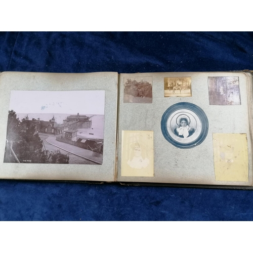 275 - Another photograph album from early 20C, leather bound containing photographs, cuttings, postcards e... 
