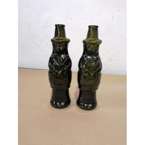 11 - A pair of unusual dark green candle holders