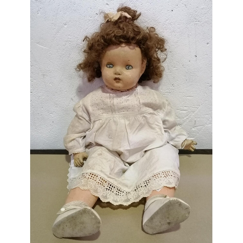 2 - A large antique doll with detailed dress and wacky hair