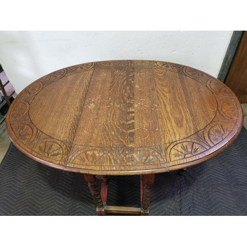 103 - 1920's Oak Dropleaf Coffee Table with Carved Top and Barley Twist Legs.

29x47x35 Inches.