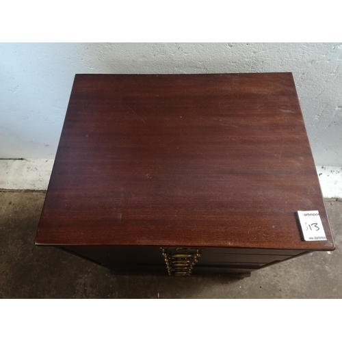 120 - Reproduction dark mahogany CD cabinet with 3 drawers and brass drop handles.