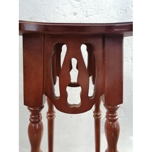 314 - Small modern carved wooden plant stand with shelf under.