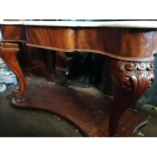 253 - Late Victorian marble topped and carved mahogany side table with shelf under (4' wide).