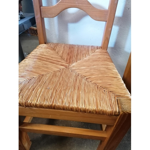 136 - Stripped pine refectory style dining table with four matching ladder back pine, string seated dining... 