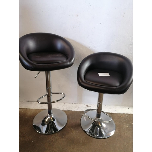 125 - Pair of chrome and leatherette upholstered adjustable bar stools.