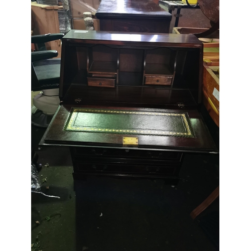 321 - Smart reproduction inlaid flame mahogany bureau with four long drawers and brass drop handles.