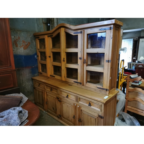 127 - Large stripped pine dresser with glass fronted doors 6'9