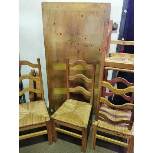 425 - Large impressive pine table with four basket weave seated chairs. Table is 67