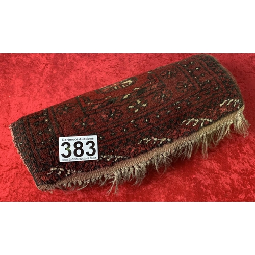 383 - A runner rug - patterned in red. Measures : 134 cm x 50 cm 0- in need of a good clean.