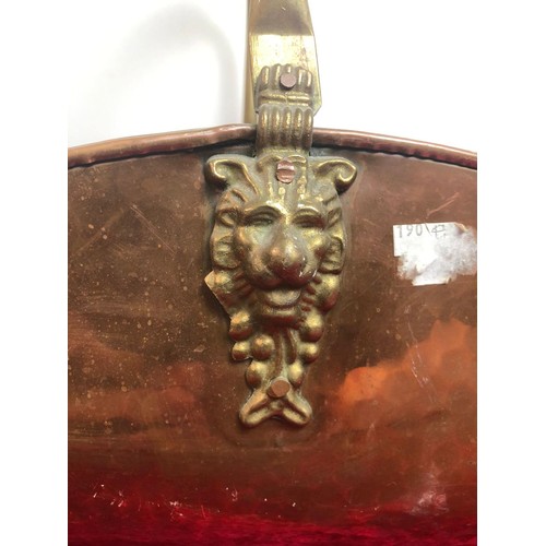 208 - Brass log carrier with porcelain handle and lion detail