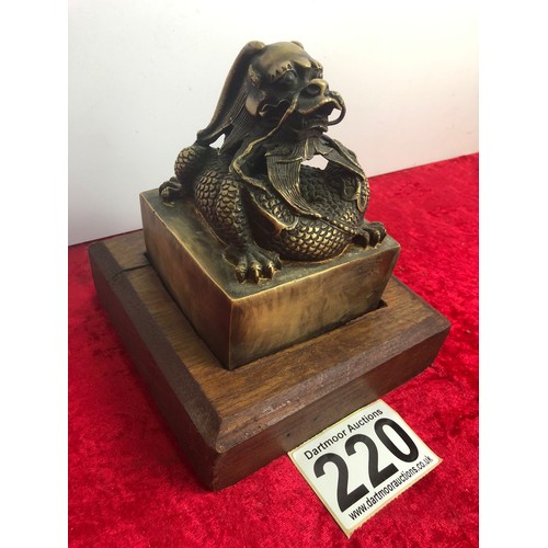 220 - Large brass Chinese dragon seal on an oak base