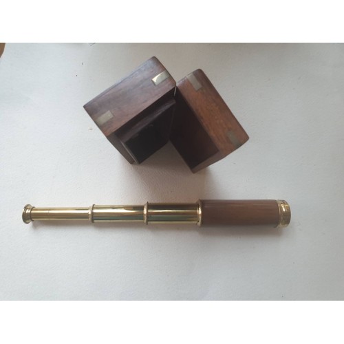 566 - A brass and wooden telescope. contained in a brass bound hardwood box.  40 cm