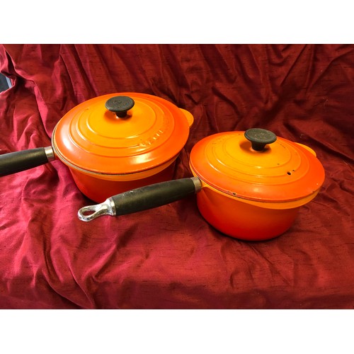 238 - 2 Le Creuset volcanic orange cast iron saucepans - sizes 18 and 20 with lids in good, used condition