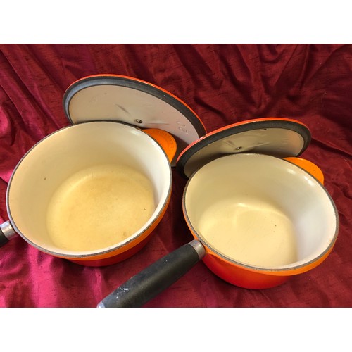 238 - 2 Le Creuset volcanic orange cast iron saucepans - sizes 18 and 20 with lids in good, used condition