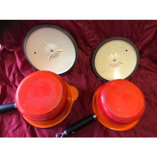 238 - 2 Le Creuset volcanic orange cast iron saucepans - sizes 18 and 20 with lids in good, used condition