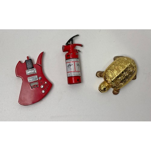 113 - Three novelty lighters, tortoise/turtle, guitar and fire extinguisher