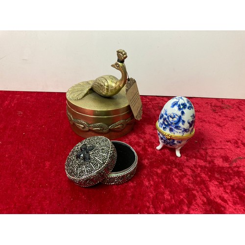 114 - Indian gold coloured peacock tinket box, egg trinket box and one other