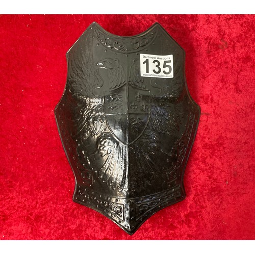 135 - Black metal armour breastplate made in England by BEL along with 2 black martial coats of arms made ... 