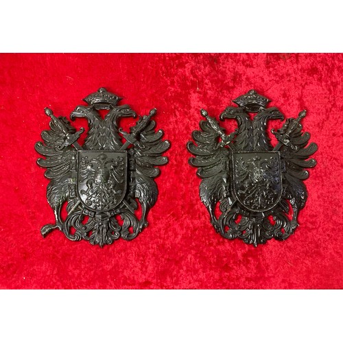 135 - Black metal armour breastplate made in England by BEL along with 2 black martial coats of arms made ... 