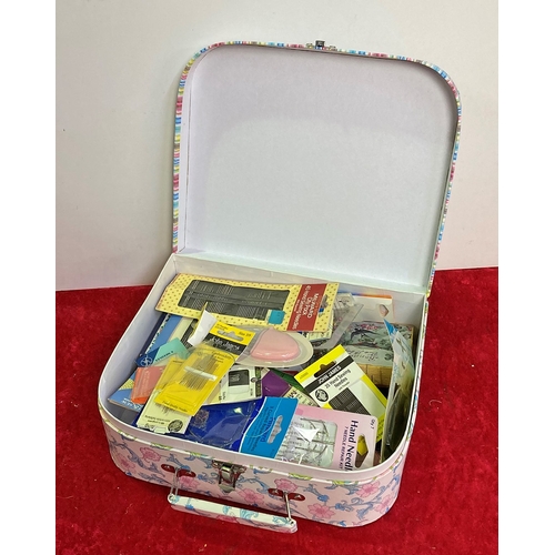 322 - A mini cardboard suitcase containing a large quantity of pins and needles - don't stand for too long... 