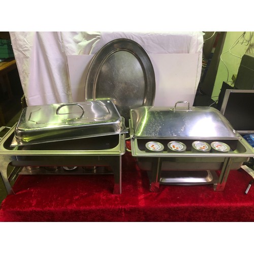 662 - Two large stainless steel food warming / serving trays and a large stainless steel tray