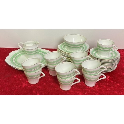 19 - Art Deco Bell china tea set inc. 2 large plates, 12 small plates, 12 saucers, 11 cups, a milk jug an... 