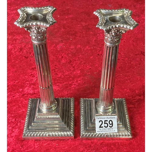 259 - Pair of silver weighted candlesticks, one inscribed 