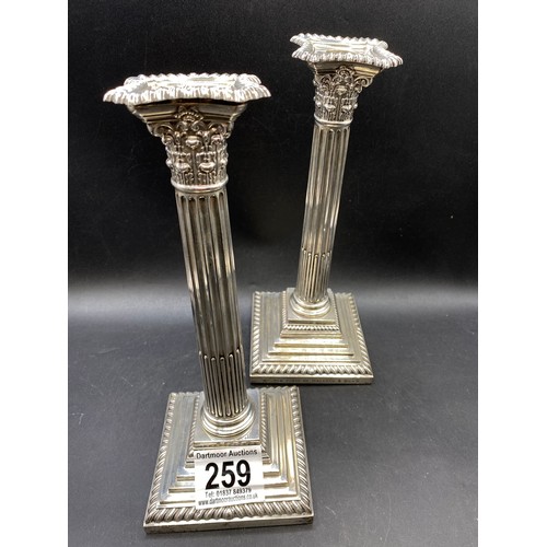 259 - Pair of silver weighted candlesticks, one inscribed 