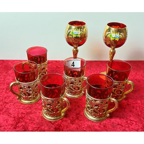4 - 6 red drinking glasses in gold plastic holders along with 2 red wine glasses with hand painted gold ... 