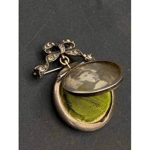 251 - Antique double memorial / mourning locket with paste surround on paste bow clip set in silver