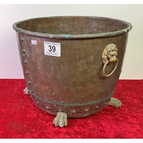 39 - Copper pot with riveted sides, claw feet and lion head handles - diameter approx 43cm, 32cm high