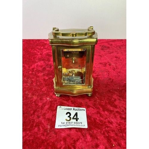 34 - Small French brass cased carriage clock with key