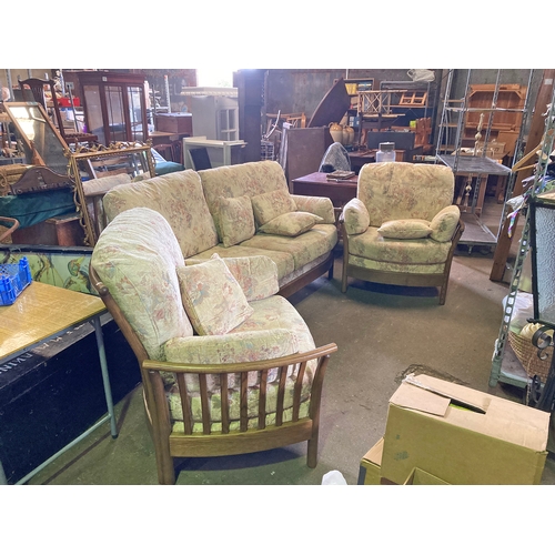 615 - An Ercol 3 piece suite in good condition, mainly cream with a floral pattern and matching cushions.