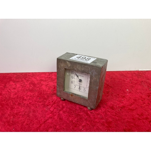 498 - A art deco style silver  metal battery operated bedside clock with embossed hammering on exterior. M... 