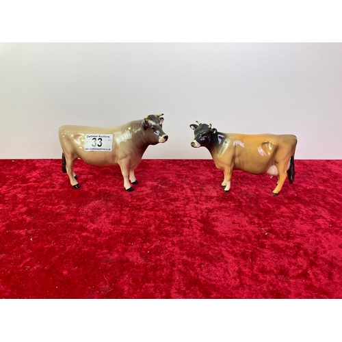 33 - A pair of Beswick Guernsey cows.  One is CH Dunsley Coy Boy no. 1422. the other one is CH Newton Tin... 