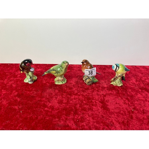 38 - A collection of four Beswick birds. Blue Tit no 992, Green Finch no. 2105, Gold Finch no. 2273, and ... 