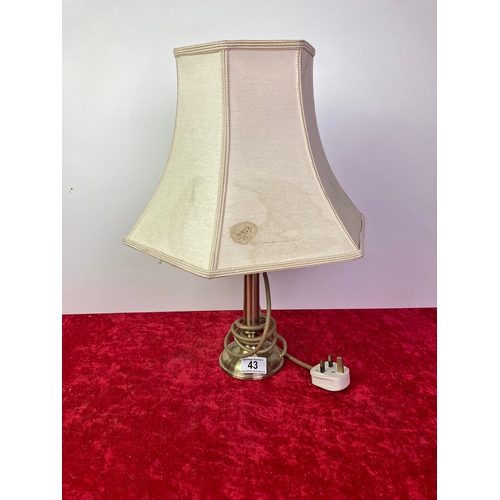 43 - A brass effect table lamp and shade.