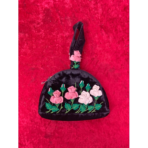 58 - A black velvet little bag with pink and white flowers .