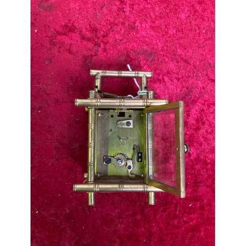 960 - A miniature travelling carriage clock with key and bamboo detailing made by Elliot in London