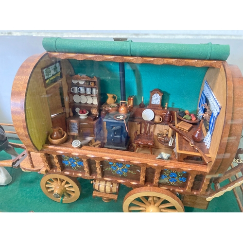 933 - Stunning hand-crafted gypsy caravan model with a ceramic carthorse in a perspex case. Case measures6... 