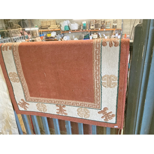 1296 - Small terracotta coloured rug