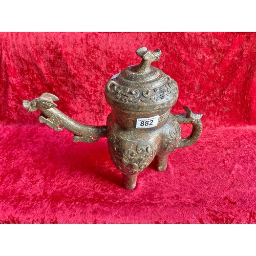 882 - A very heavy three leg bronze Chinese wine ewer with ornate spout and lid