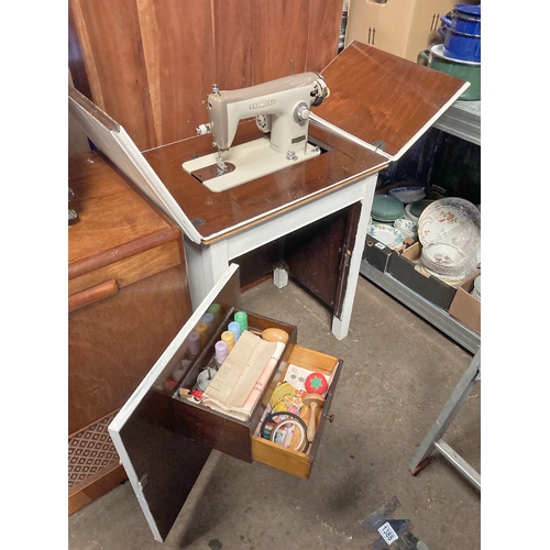 1371 - Cupboard sewing desk with Model 1360A sewing machine and shelf inside cupboard containing sewing ite... 