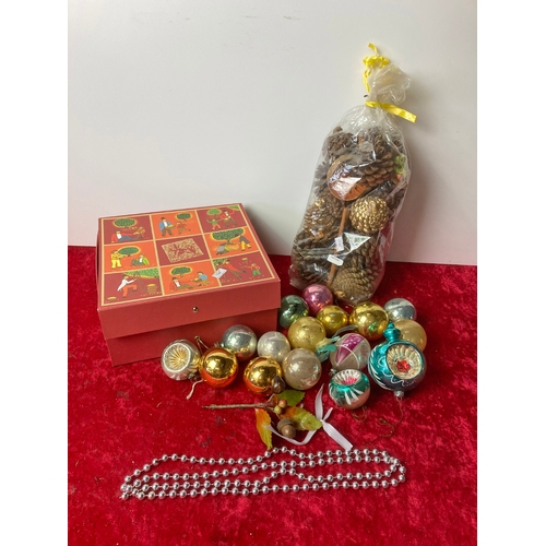 95 - A box containing vintage Christmas tree baubles along with a bag of Christmasy Pine cones