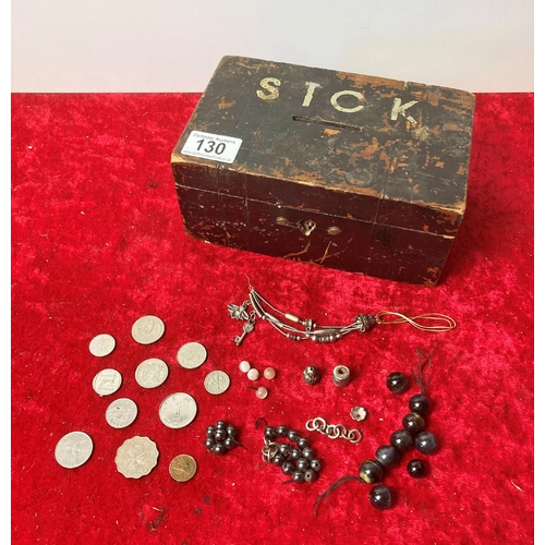 130 - Wooden money box containing a small quantity of foreign coins