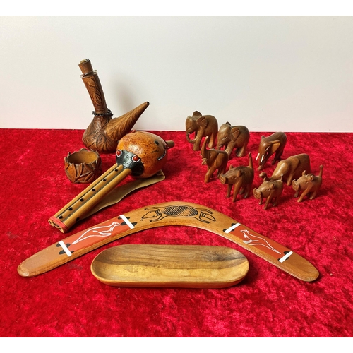 18 - A collection of wooden, carved items including a boomerang and elephants (the boomerang does not qua... 